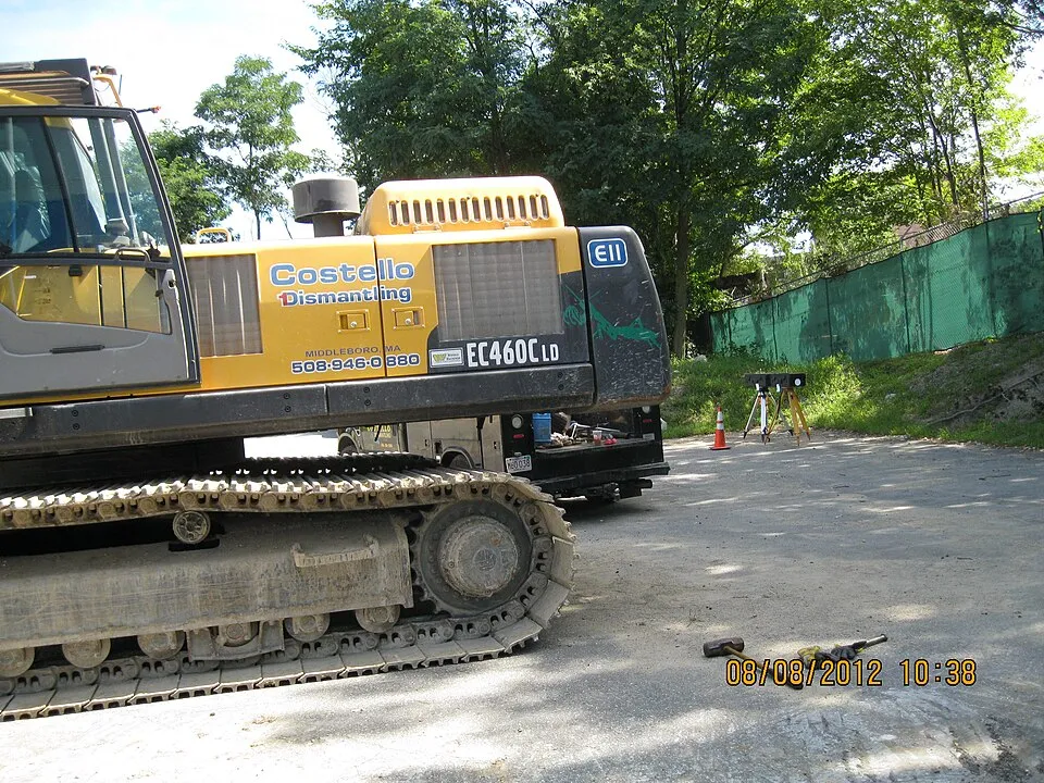 Context photograph: 1038 Costello heavy equipment with air monitoring station in background (7747398638); science context, not an identified product or supplier on this page.