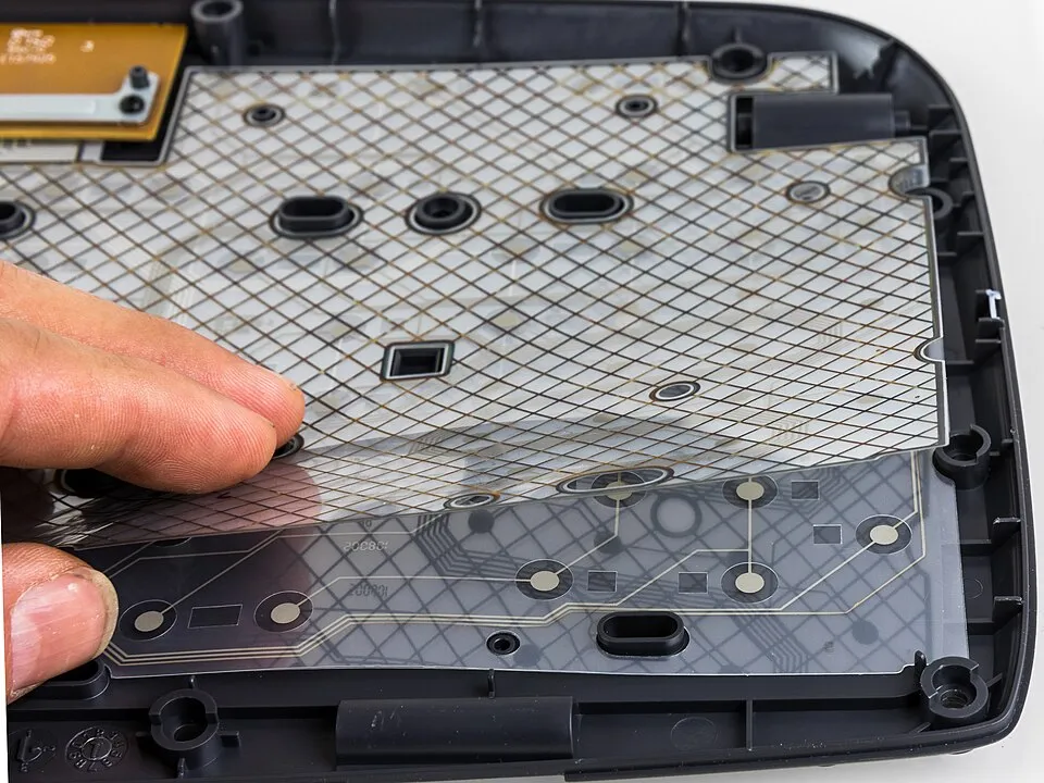 Context photograph: Logitech Cordless Desktop EX110 - plastic sheet layers with circuit paths-3082; polymer context, not an identified product or supplier on this page.
