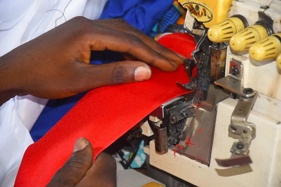 Context photograph: Sewing a new cloth with polyester fabric 7; textile context, not an identified product or supplier on this page.