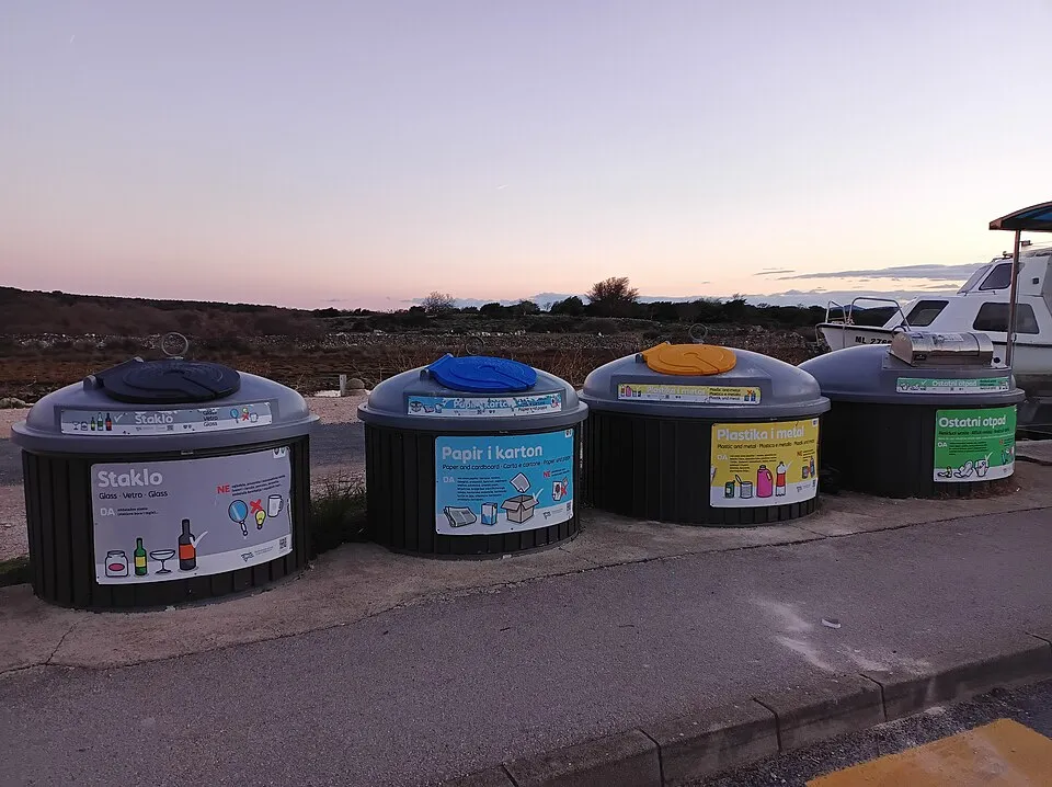 Context photograph: Recycling containers in Osor; operations context, not an identified product or supplier on this page.