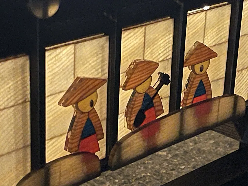 Context photograph: LED-backlit transparent wood panels in Goze Mokudon bench-shaped andon lantern; timber context, not an identified product or supplier on this page.