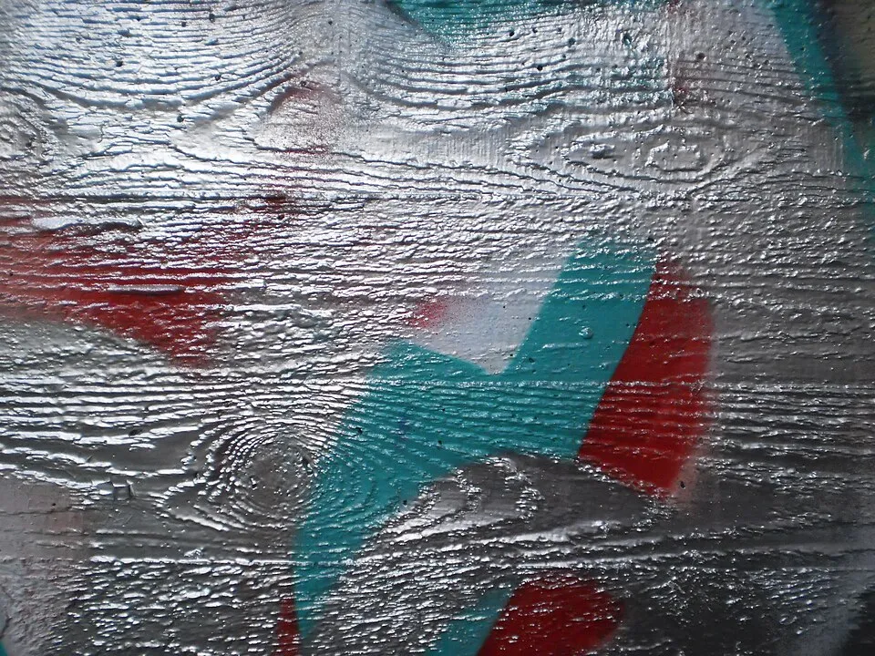 Context photograph: Light reflections of silver wood grain texture on concrete wall, details of graffiti in Marburg 2017-06-10; timber context, not an identified product or supplier on this page.